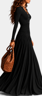 Mahaute Gracia long black dress with V-neck, buttoned bodice, ruched waist, and flowing skirt worn by a model