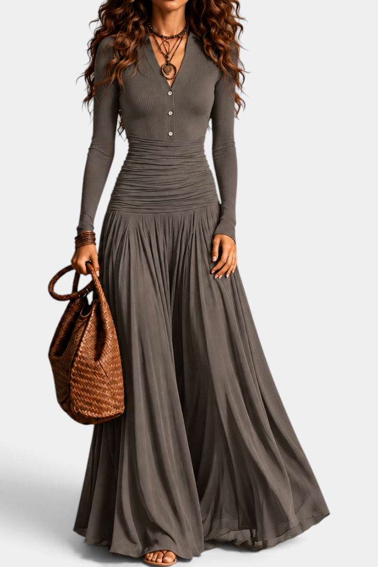 Mahaute Gracia long grey dress with V-neck, button placket, ruched waist, and flowing skirt, styled with a brown bag.