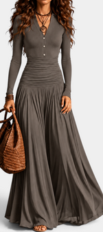 Mahaute Gracia long grey dress with V-neck, button placket, ruched waist, and flowing skirt, styled with a brown bag.
