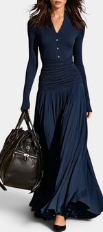 Mahaute Gracia navy blue long-sleeved maxi dress with a V-neck, button placket, and ruched waist on a model.