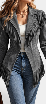 Mahaute grey faux suede fitted jacket with tailored collar and long fringe detailing on shoulders and hem.