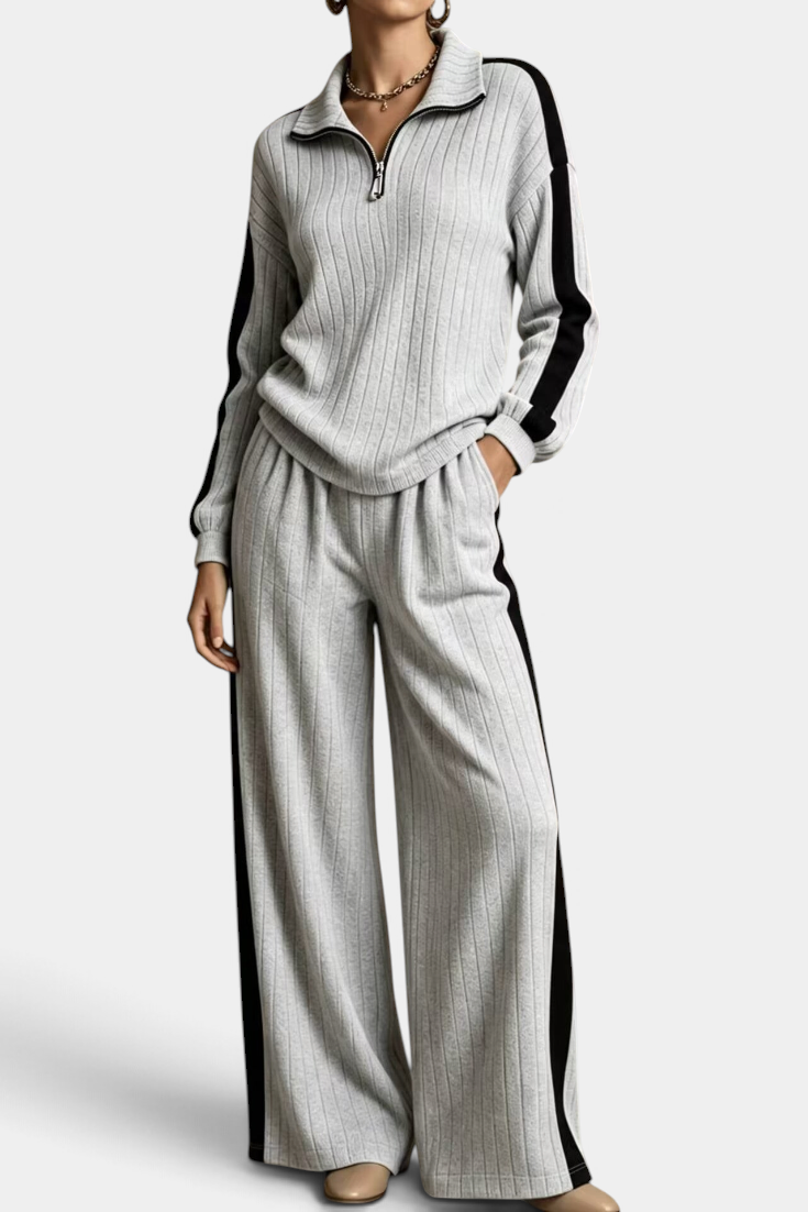 Mahaute Cocoon grey ribbed knit set with zip-up sweater and wide-leg trousers featuring black side stripes.