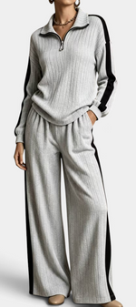 Mahaute Cocoon grey ribbed knit set with zip-up sweater and wide-leg trousers featuring black side stripes.