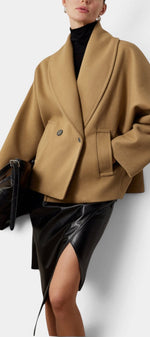 Mahaute Helena camel wool-blend cropped coat with shawl collar and double-breasted front worn over a black turtleneck