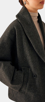 Mahaute Helena charcoal grey short coat with a wide shawl collar and double-breasted design worn over a beige top