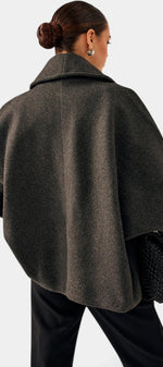 Mahaute Helena charcoal grey short coat with a wide shawl collar and loose, structured fit seen from the back