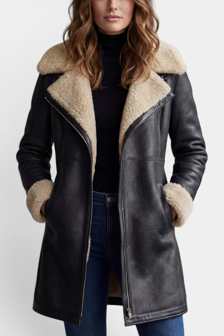 Manteau mi-long en faux cuir noir Mahaute Hildegarde avec col fourré et fermeture zippée, style élégant et moderne.