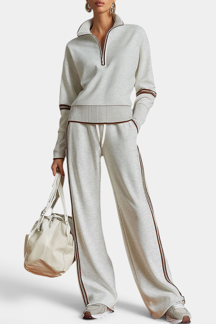 Mahaute Ismay knit set with zip-up collar and wide-leg trousers featuring contrast side stripes in beige and brown.