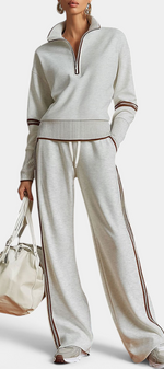 Mahaute Ismay knit set with zip-up collar and wide-leg trousers featuring contrast side stripes in beige and brown.