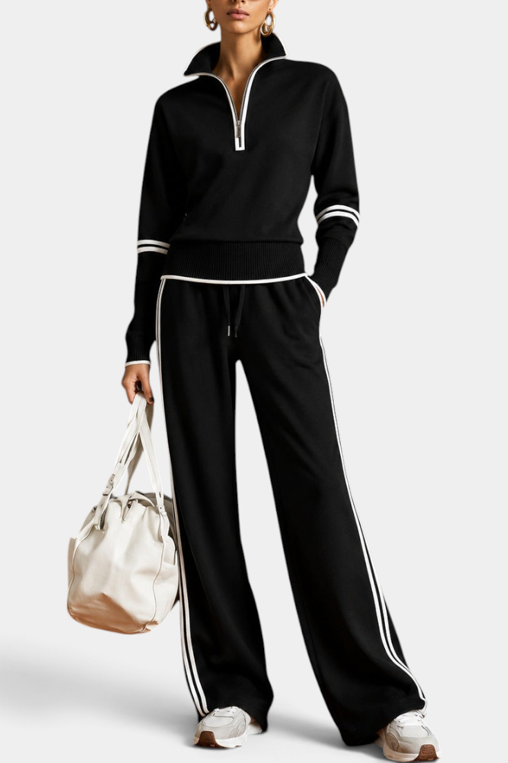 Mahaute Ismay black knit set with zip-up collar, wide-leg trousers, and white contrast stripes on a model.