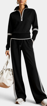 Mahaute Ismay black knit set with zip-up collar, wide-leg trousers, and white contrast stripes on a model.