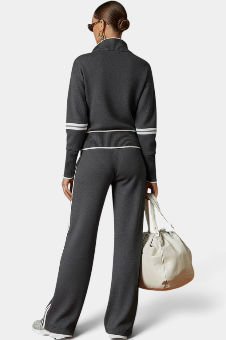 Mahaute Ismay charcoal grey knit set with zip-up collar, ribbed cuffs, and white contrast stripes on back view
