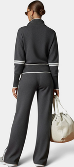 Mahaute Ismay charcoal grey knit set with zip-up collar, ribbed cuffs, and white contrast stripes on back view