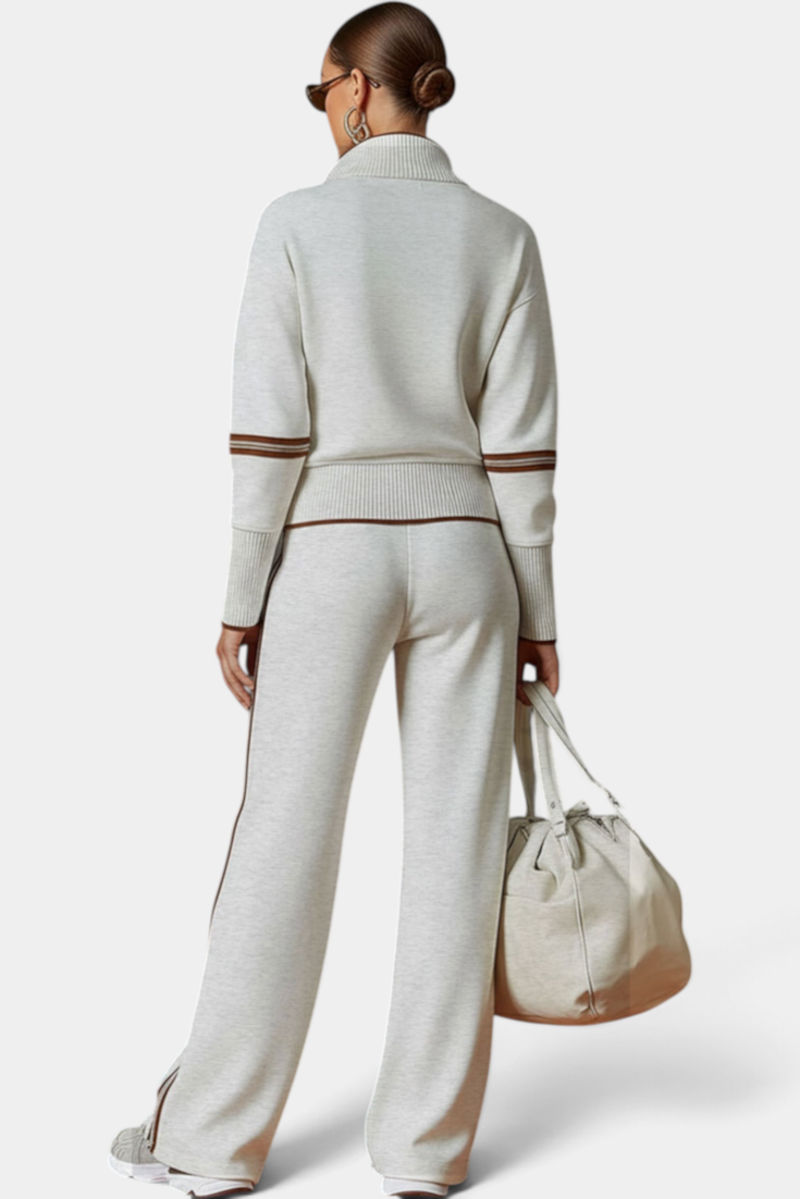 Mahaute Ismay beige knit lounge set with zip-up collar, ribbed cuffs, and brown contrast side stripes on back view.