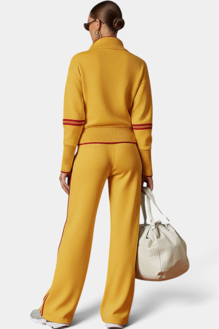 Mahaute Ismay mustard yellow knit set with zip-up collar, ribbed cuffs, and red side stripes on pants and sleeves.