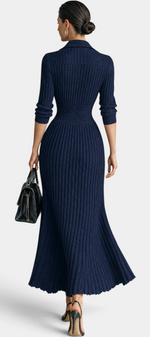 Mahaute Jessamine long navy blue ribbed knit dress with shirt collar and cinched waist, back view on a model.
