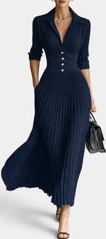 Mahaute Jessamine navy blue ribbed knit maxi dress with a collared neckline, cinched waist, and gold button details.