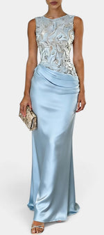 Mahaute Joni light blue satin evening gown featuring a floral embroidered bodice and a draped waist detail.