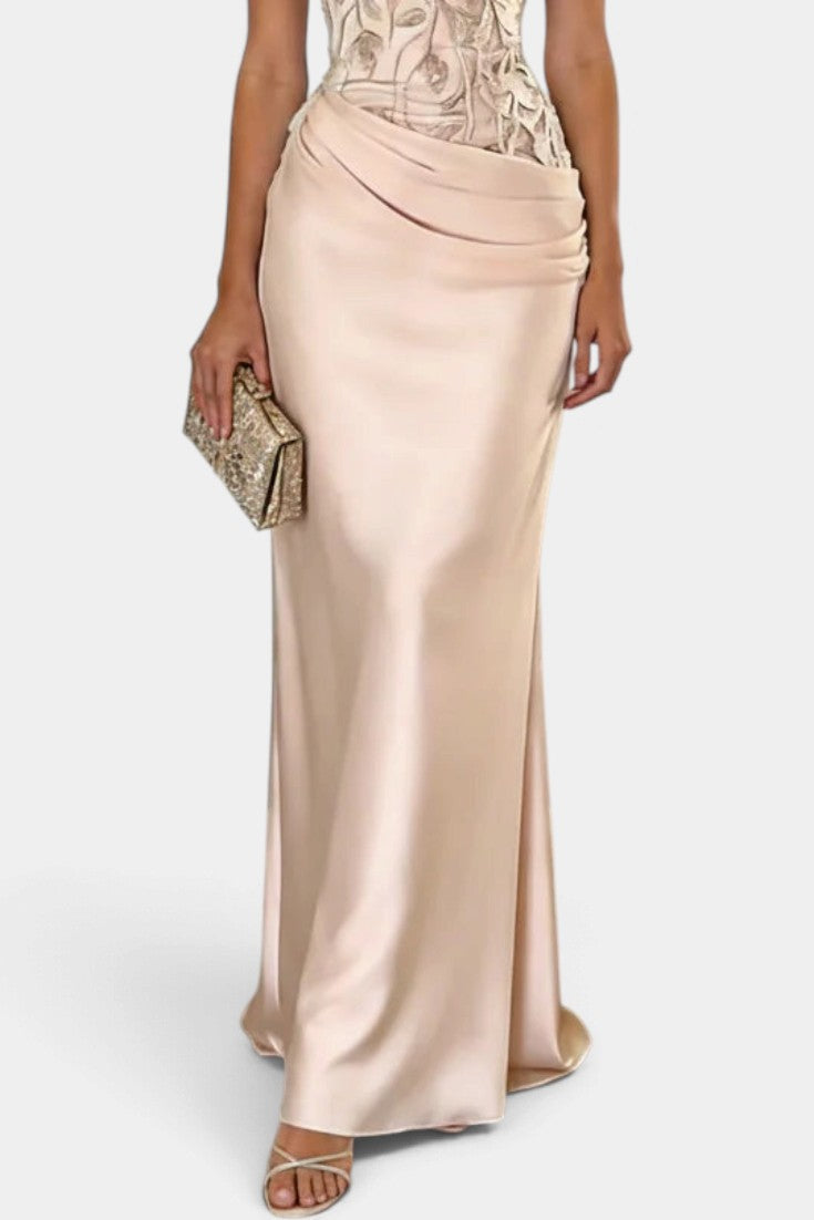 Mahaute Joni long champagne satin evening gown featuring a floral embroidered bodice and a draped waist detail.
