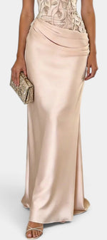 Mahaute Joni long champagne satin evening gown featuring a floral embroidered bodice and a draped waist detail.