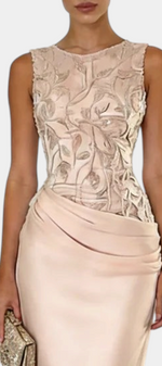 Mahaute Joni sleeveless evening gown with a floral embroidered bodice and a draped satin skirt in champagne beige.