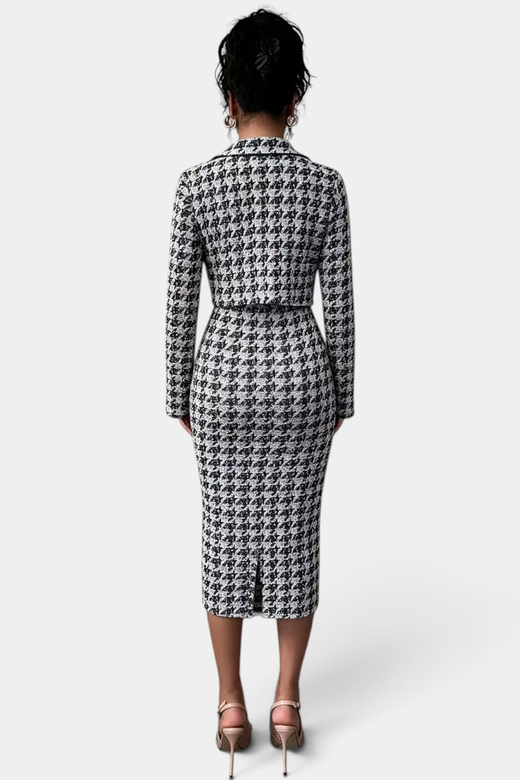 Back view of a Mahaute Kalina midi dress and blazer set in a black and white houndstooth pattern on a model.