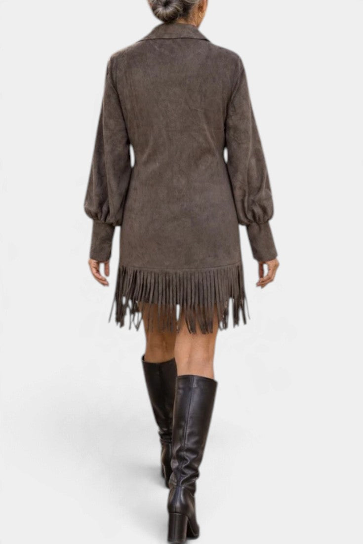 Back view of Mahaute Karoly short brown faux suede dress with puff sleeves and fringe hem worn with tall boots