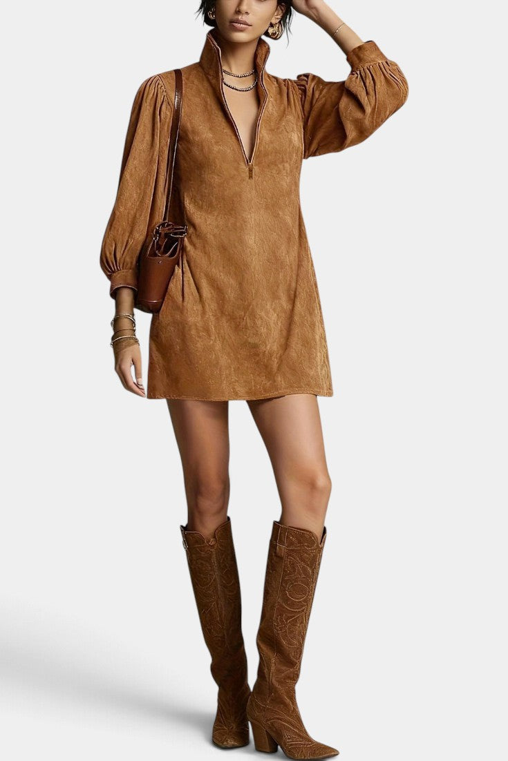 Model wearing Mahaute Karoly short brown faux suede dress with zip collar and puff sleeves, styled with tall boots.