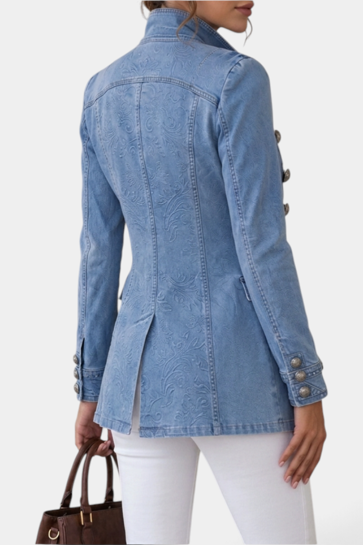Mahaute light blue denim jacket with embossed floral pattern, high collar, and decorative silver buttons, back view.