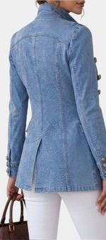Mahaute light blue denim jacket with embossed floral pattern, high collar, and decorative silver buttons, back view.