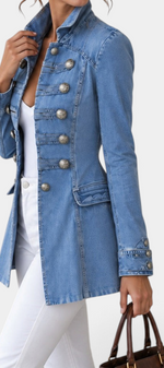 Mahaute light blue denim jacket with a high collar and ornate silver decorative buttons in a fitted military style.