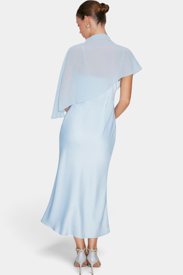 Back view of Mahaute Carys midi satin dress in light blue with an asymmetrical cape and elegant draped neckline