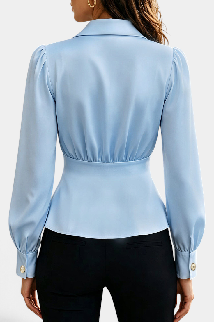 Mahaute light blue long-sleeve blouse with tailored collar, cinched waist, and gold button cuffs, back view.