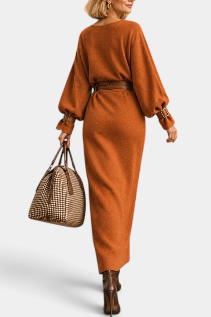 Mahaute long rust-colored belted dress with puff sleeves and patch pockets, worn with a brown handbag and boots.