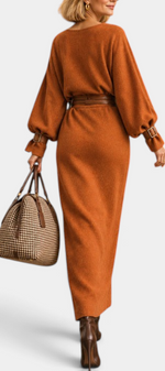 Mahaute long rust-colored belted dress with puff sleeves and patch pockets, worn with a brown handbag and boots.