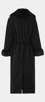 Back view of Mahaute Lalie long black coat with faux fur collar and cuffs and a waist-cinching tie belt