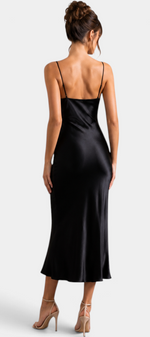 Mahaute long black satin slip dress with thin straps worn by a model from the back view