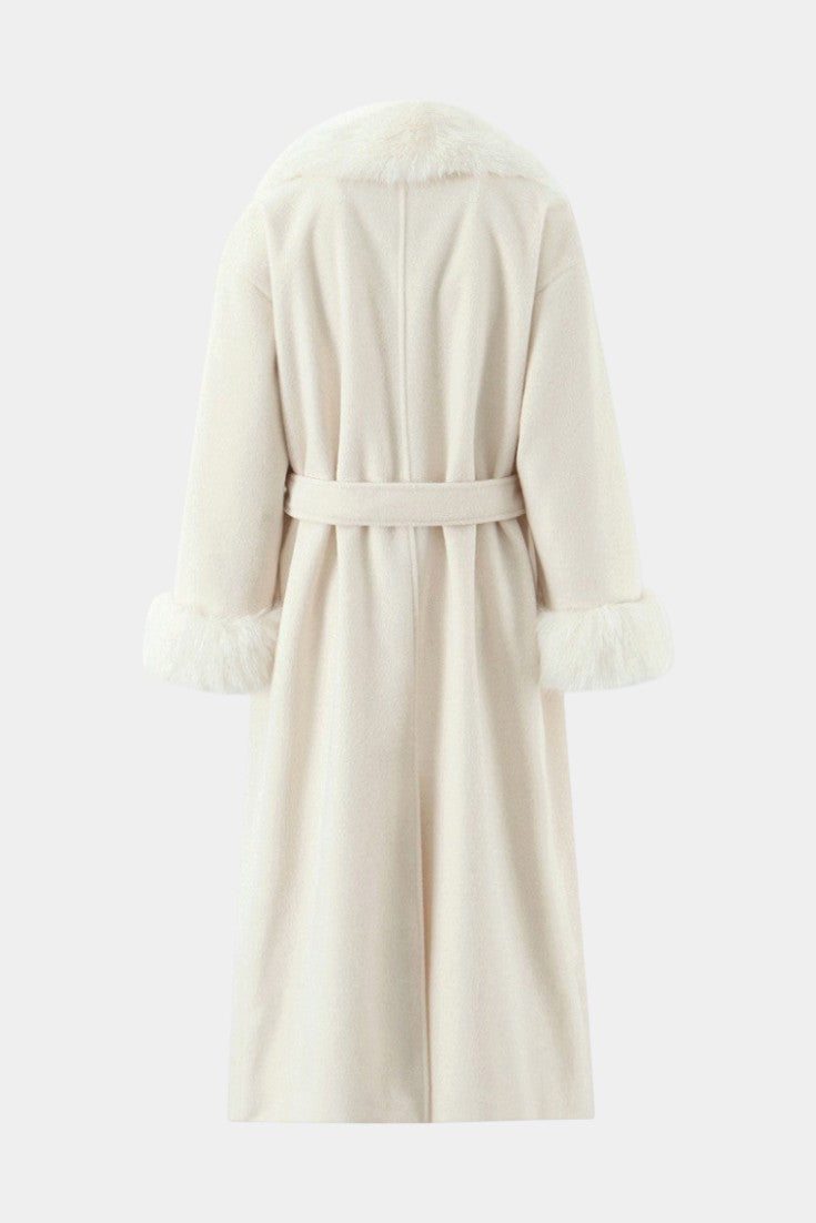 Back view of Mahaute Lalie long cream coat with faux fur collar and cuffs and a belted waist