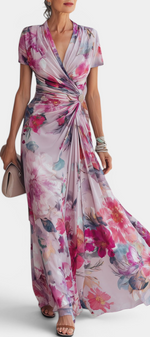 Mahaute long floral wrap dress in watercolor print with draped waist, jewel button detail, and short sleeves.