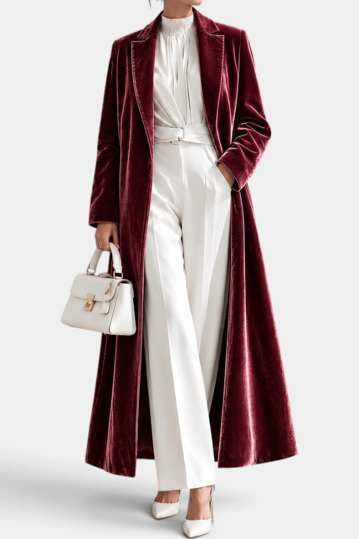 Mahaute long wine red velvet coat with elegant lapels worn over white trousers and a blouse
