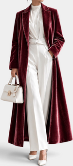 Mahaute long wine red velvet coat with elegant lapels worn over white trousers and a blouse