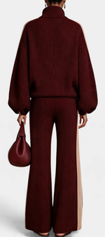 Mahaute Luella ribbed knit set in burgundy with cream side stripes, featuring a zip-up jacket and wide-leg trousers.