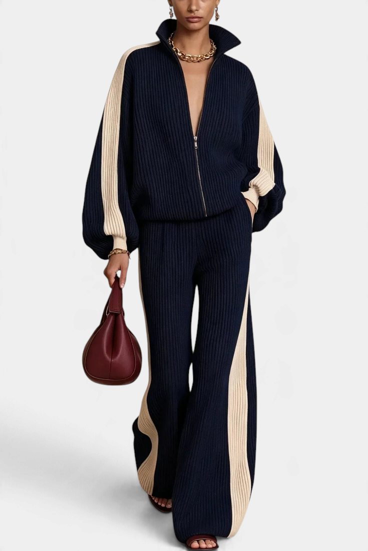 Mahaute Luella ribbed knit set featuring a navy zip-up jacket and wide-leg trousers with cream contrast side stripes.