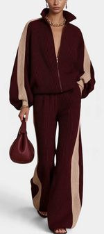 Mahaute Luella ribbed knit set in burgundy and beige with a zip-up jacket, wide-leg trousers, and contrast stripes.