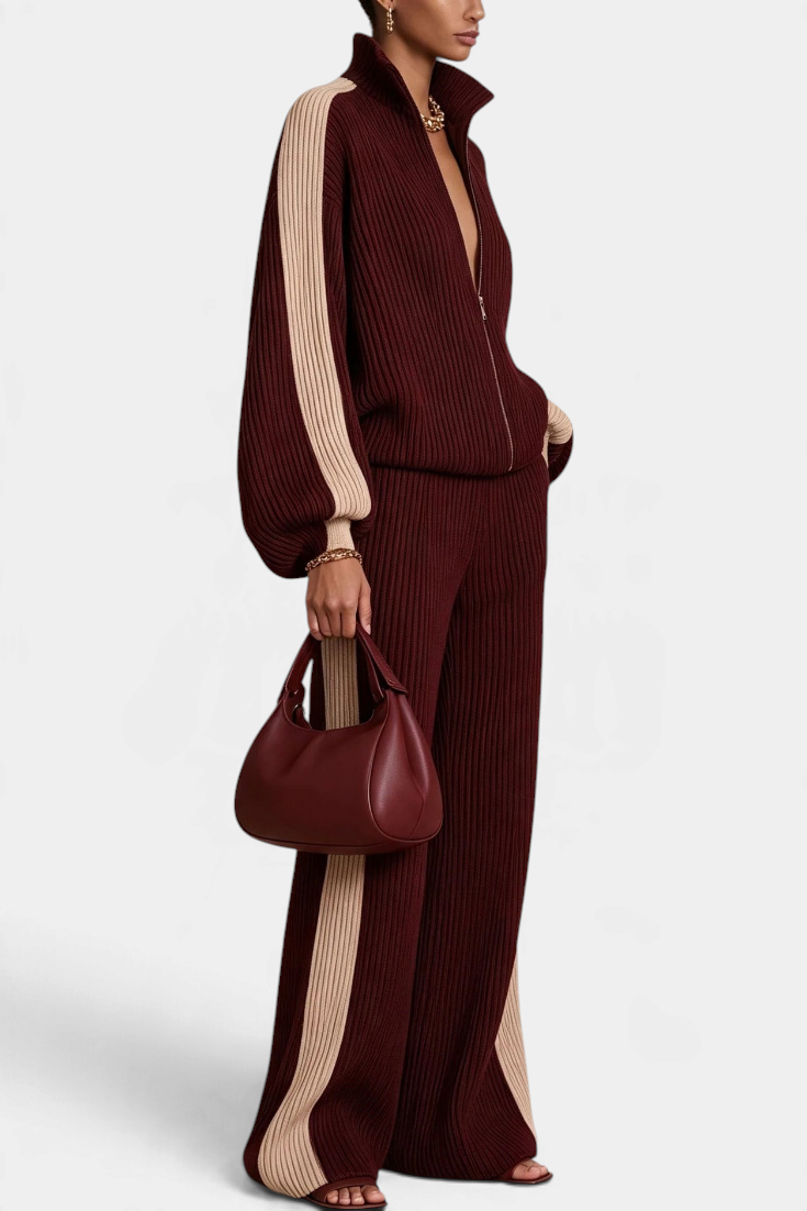 Mahaute Luella ribbed knit set in burgundy with beige contrast side stripes, featuring a zip-up jacket and wide pants.