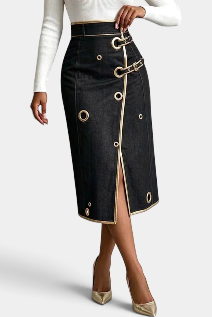 Mahaute Lyséa high-waisted black denim midi skirt with gold eyelets, buckle straps, and a front slit.
