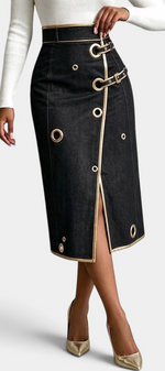 Mahaute Lyséa high-waisted black denim midi skirt with gold eyelets, buckle straps, and a front slit.