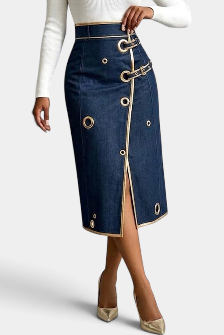 Mahaute Lyséa high-waisted dark denim midi skirt with metallic eyelets, buckle straps, and a front slit.