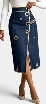 Mahaute Lyséa high-waisted dark denim midi skirt with metallic eyelets, buckle straps, and a front slit.
