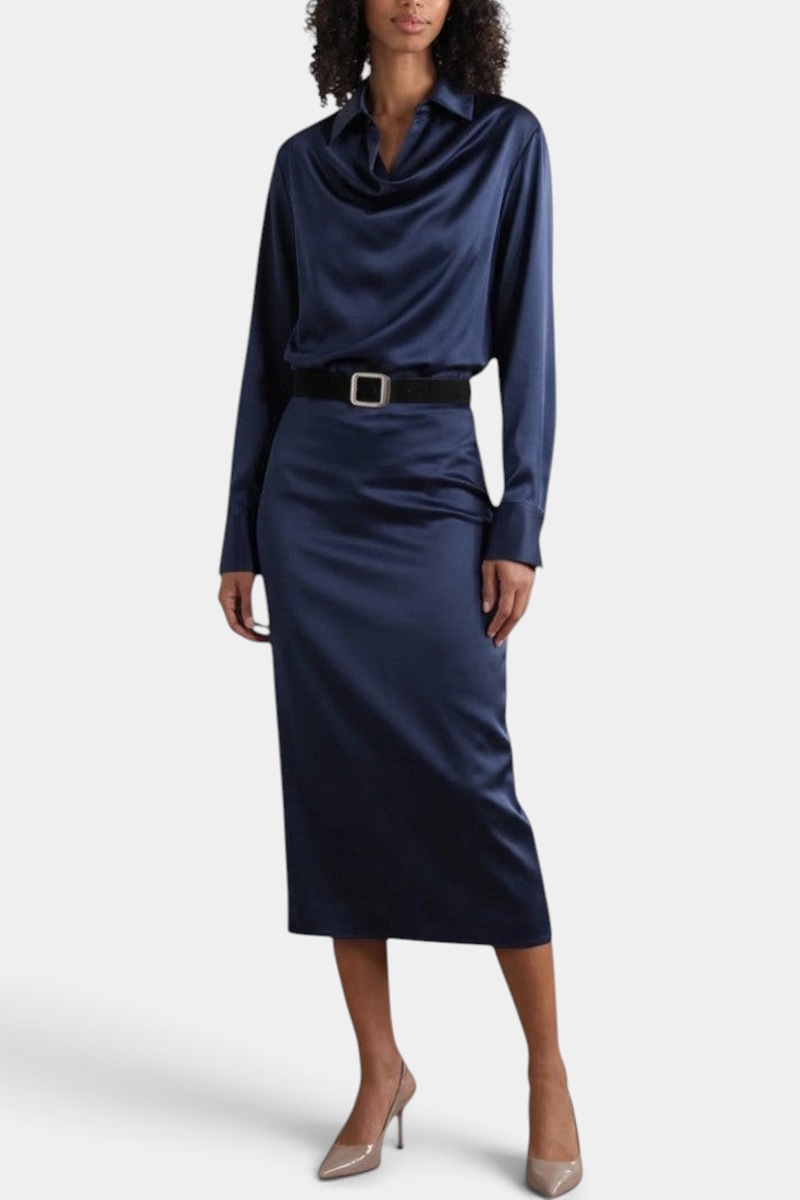 Mahaute Macarena navy blue satin midi dress with a draped shirt collar, long sleeves, and a square buckle belt.